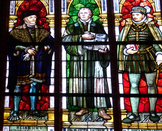 Fenster in der Sternberger Kirche um Gedenken an die Reformation. Es zeigt in idealisierter Buntglasdarstellung Martin Luther zwischen den beiden mecklenburgischen Herzögen Johann Albrecht I. und Heinrich V.