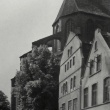 Das schwarzweiß Foto zeigt im Vordergrund zwei Wohnhäuser, im Hintergrund ist der Chor der Wismarer Nikolaikirche zu sehen.